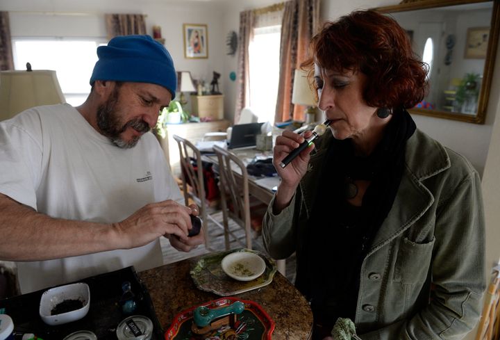 Colorado medical marijuana patient Teri Robnett, right, uses a vape pen to manage chronic fibromyalgia. A majority of Coloradans said they supported legal marijuana in a recent poll.