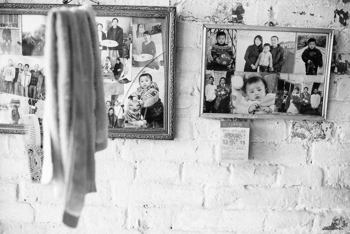 Photos of Liu's family hang in their home.