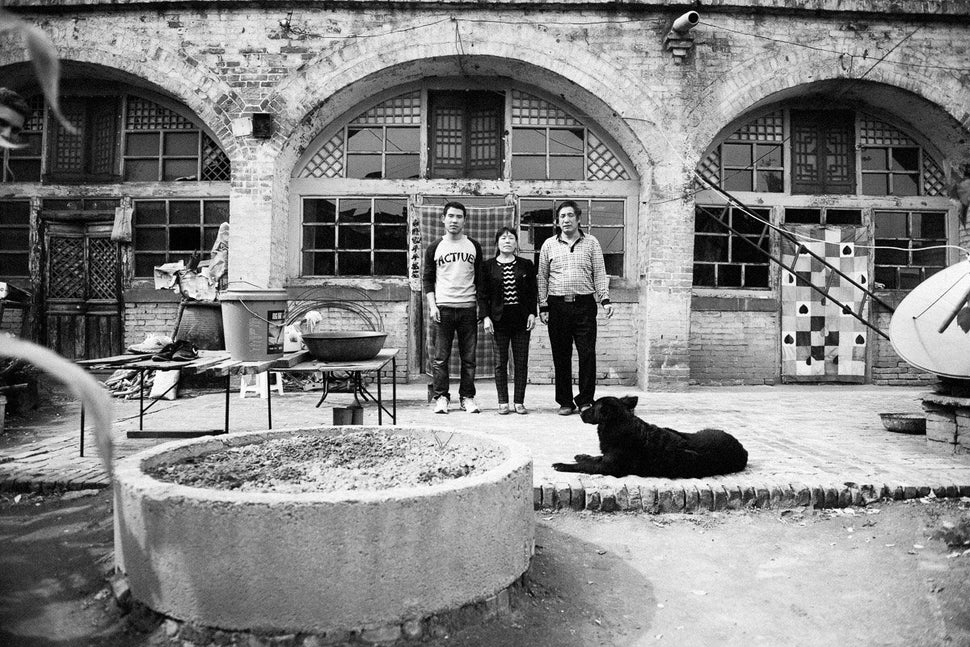 Liu, his wife and his son outside their home in Yaoyu Village.