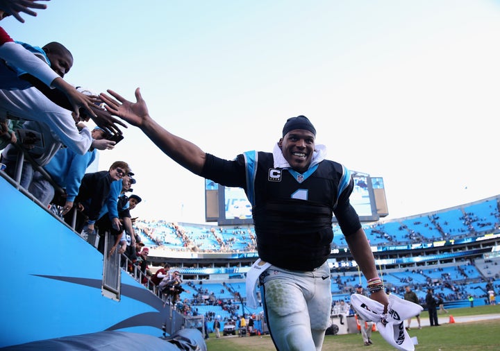 Newton celebrates with fans after defeating the Washington Redskins on Nov. 22, 2015, in Charlotte, North Carolina.