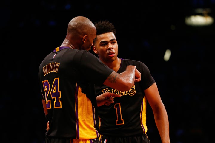 Kobe Bryant talks strategy with rookie point guard D'Angelo Russell during their game against the Brooklyn Nets on Nov. 6, 2015, at the Barclays Center. The Lakers won, 104-98.