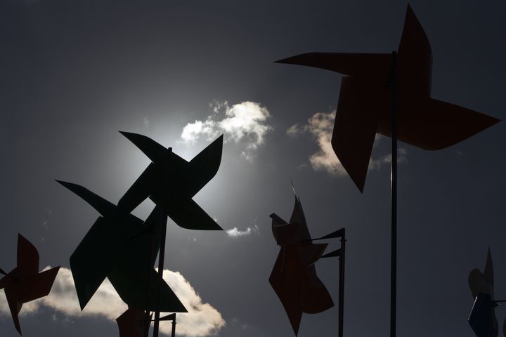 Paper windmills are on display in Paris ahead of next week's climate talks.