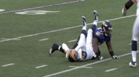 Rams quarterback Case Keenum grabs his head after being concussed against the Baltimore Ravens.