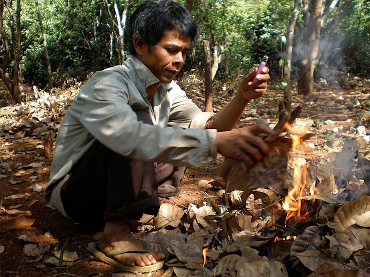 Ly Kamoun practicing slash-and-burn agriculture in his field, 2008.