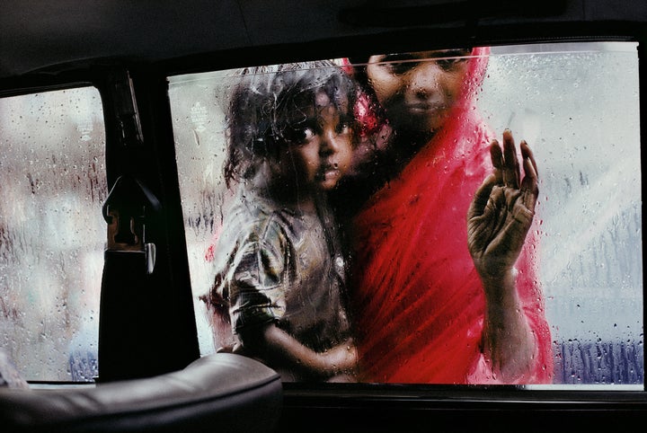 Mother and child at a car window, Mumbai, Maharashtra; 1993.