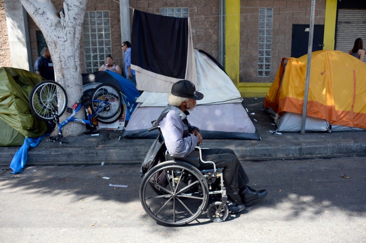 LOS ANGELES, CA - SEPTEMBER 23: A homeless man rolls down the street to a soup kitchen in skid row September 23, 2015, in Los Angeles, California. Mayor Eric Garcetti and City Council members declared public emergency, the first city in the nation to take drastic step in response to increase in homelessness and that they're ready to spend $100 million per year to fight it.