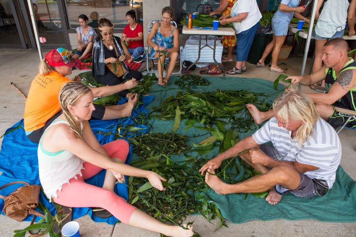 Volunteers weave the mile-long lei for Paris.