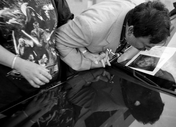 Mohammad and Talat Hamdani kiss a photo of their son on Sept. 17, 2001.