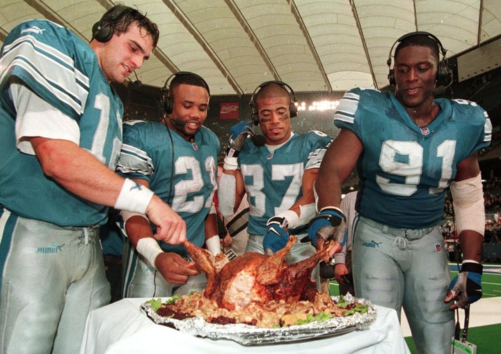 Detroit Lion players Gus Frerotte, Greg Hill, Johnnie Morton and Robert Porcher sample FOX TV's Jon Madden's turkey after their home game against the Chicago Bears on Nov. 25 1999.