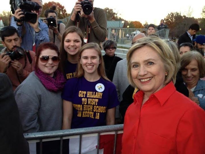 Abby Schulte, Megan Adam and Kylea Tinneas pose with Hillary Clinton following a campaign event in Coralville, Iowa, on Nov.&