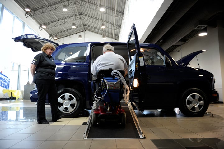 Service representative Debbie Pixler watches as Rod Hoffman works the ramp in the MV-1 during a showcase of the new MV-1 line of accessible vans at Medved on Thursday, March 8, 2012.