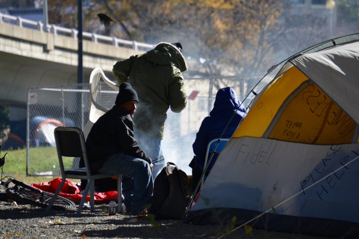 Homeless campers heating food near the Watergate Hotel in Washington, D.C.