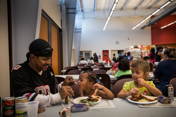 LeManuel Farrish helps his cousin, Makayla Farrish, finish her dinner at Cathedral Kitchen in Camden, New Jersey. Cathedral Kitchen is a mutli-service soup kitchen that has been serving the Camden homeless community since 1976. 