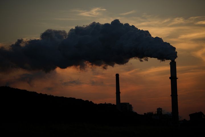Emissions rise from the Northern Indiana Public Service Co. (NIPSCO) Bailly generating station on the shore of Lake Michigan at dusk in Chesterton, Indiana, U.S., on Wednesday, Oct. 7, 2015.