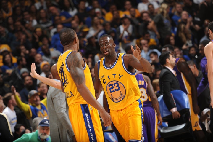 Golden State Warriors' Draymond Green, right, high-fives teammate Andre Iguodala during the spectacular performance.