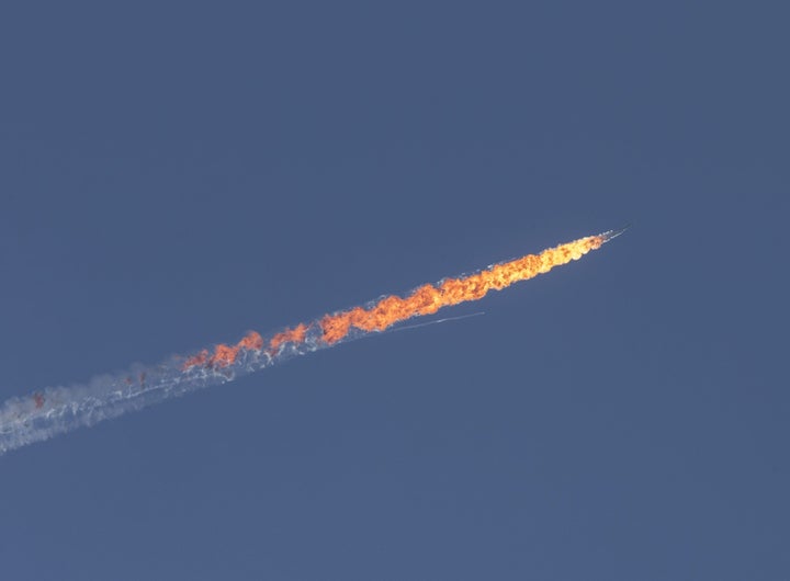 A Russian warplane goes down in Syria's northwestern Turkmen town of Bayirbucak near Turkeys border on November 24, 2015.