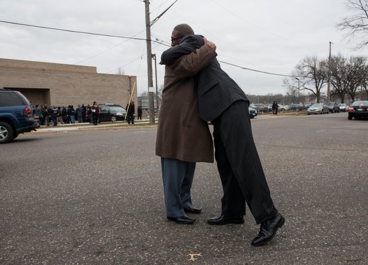 Two attendees embrace outside the funeral service of Jamar Clark at Shiloh Temple on November 25, 2015 in Minneapolis, Minnes