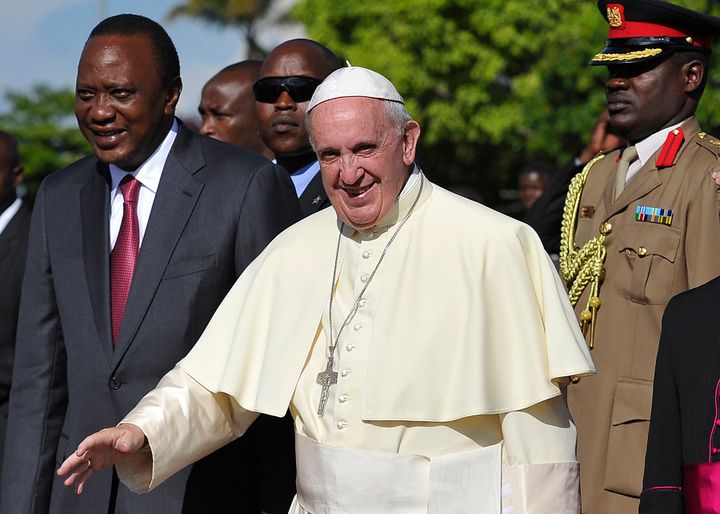 Pope Francis (C), flanked by Kenyan President Uhuru Kenyatta (L) walks to board his plane on November 27, 2015 in Nairobi on his way to Kampala, Uganda.