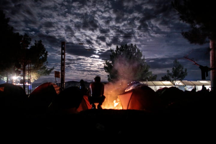 People huddle around a bonfire near Idomeni on Thursday.