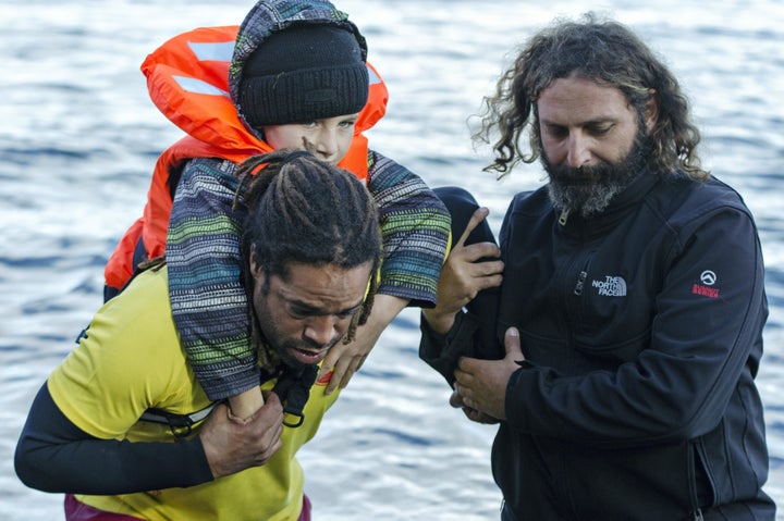 Volunteers help refugees arriving in Lesbos on Nov. 26, 2015.