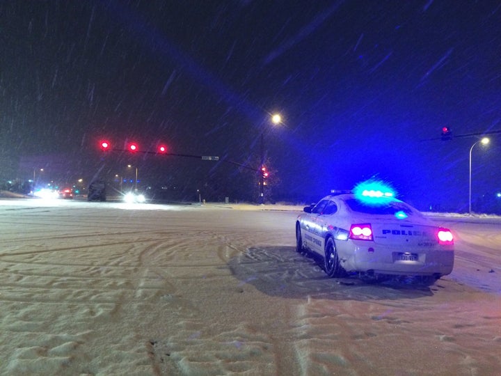 A police car is seen Friday night at the intersection of Fillmore St. and Centennial Blvd., near the Planned Parenthood clinic in Colorado Springs.