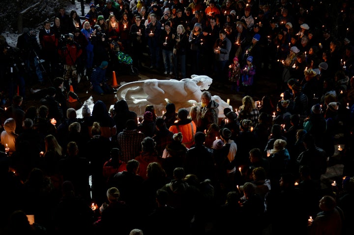 Hundreds gather around the University of Colorado at Colorado Springs Mountain Lion statue during a candlelight vigil at the Gallogy Events Center November 28, 2015 for UCCS police officer Garrett Swasey.