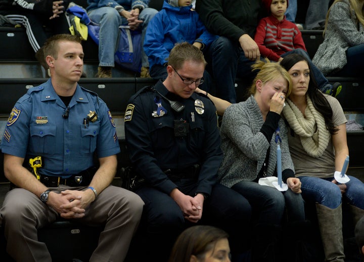 University of Colorado Colorado Springs police officer Jerod Heidrick, second from left, takes a moment as his friend Courtney Vanous, third from left, a UCCS police dispatcher, is comforted by Stephanie Chervenyak, right, a former UCCS police officer, during a vigil for fallen UCCS officer Garrett Swasey, Heidrick's police partner, at the Gallogy Events Center November 28, 2015. Colorado State Patrolman Sgt. Daniel Haley, left, was in attendance to support Heidrick and Swasey.