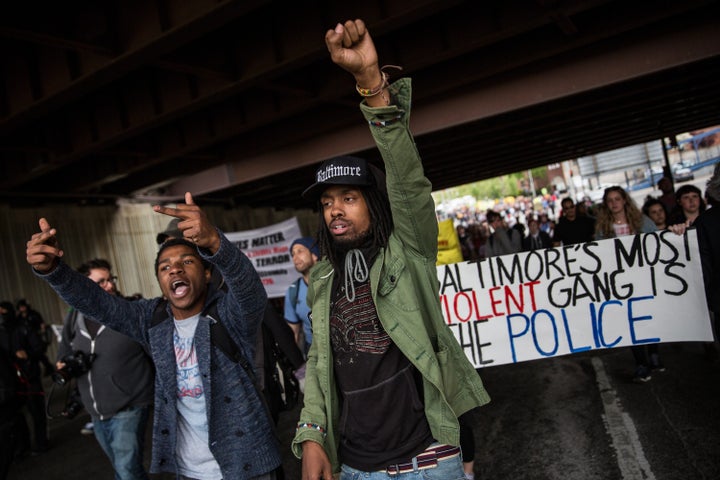 A police helicopter monitors protesters marching in support of Maryland state attorney Marilyn Mosby's announcement that char