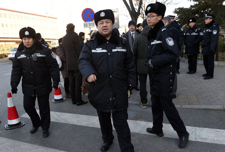 Chinese police stand guard outside the Beijing City High Court earlier this month.