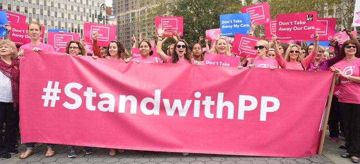Activists in New York City hold a Planned Parenthood banner to demonstrate their support for the organization.
