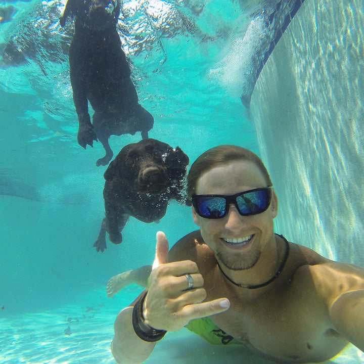 Alex Schulze poses underwater with Maverick and Lila.