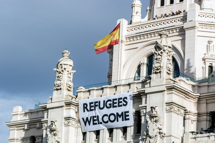 A view of Madrid City Hall with a banner that welcomes refugees.