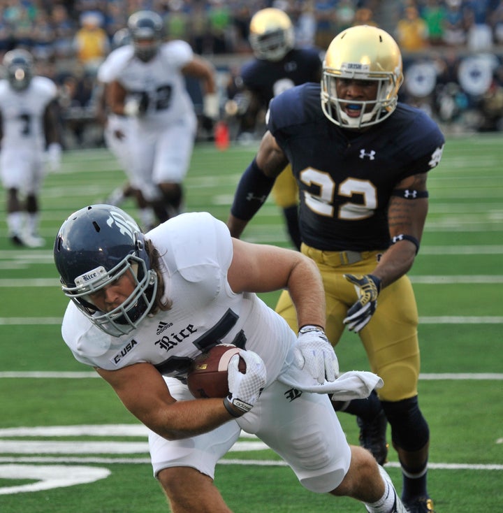 Notre Dame linebacker Joe Schmidt tackles Rice running back Luke Turner during a NCAA football game with Rice Saturday, Aug. 30, 2014 in South Bend, Ind.