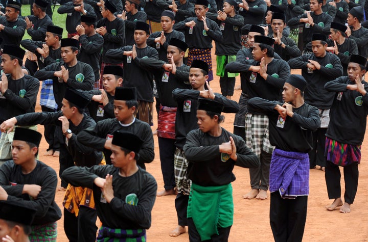 Members of the Nadlatul Ulama organization perform a traditional Indonesian martial art during a ceremony to mark the 85th anniversary of the Nahdlatul Ulama in Jakarta on July 17, 2011. The Nahdlatul Ulama is the largest Muslim organization in Indonesia, and one of the largest independent Islamic organizations in the world, with more than 50 million members.