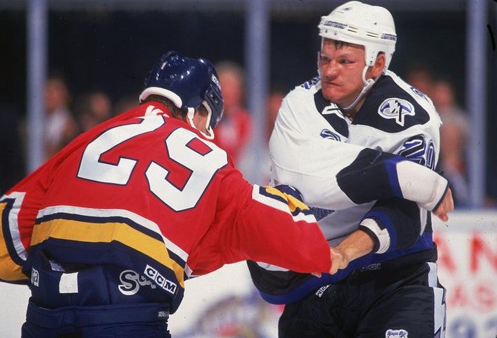 Rudy Poeschek, right, during a fight in the 1990s. Poeschek is one of more than 80 former NHL players suing the league over concussions.