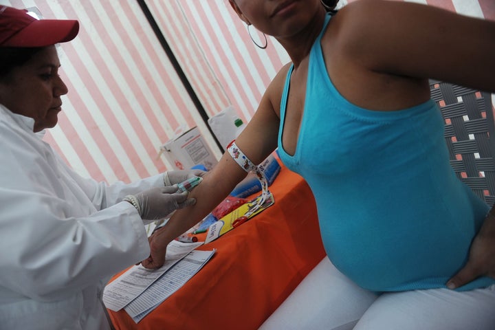 A pregnant woman takes a rapid HIV/AIDS medical test during a fair organized for the Xochiquetzal Foundation in Managua on November 23, 2011. Every six hours, a Nicaraguan contracted the virus of HIV / AIDS during the first six months of this year, and pregnant women are one of the most affected, organizations fighting the disease warned.