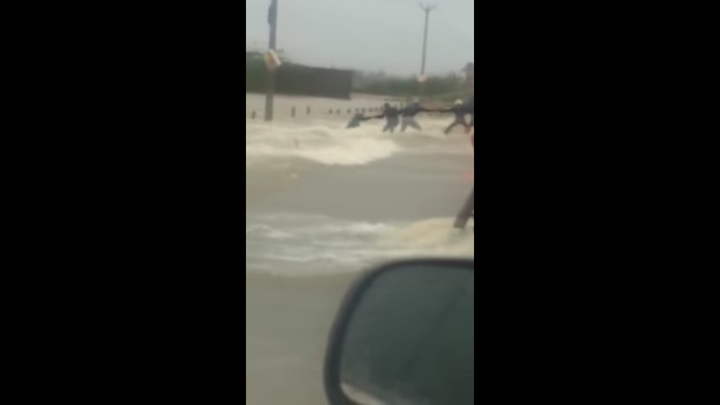 People rushed to rescue a man who got sucked into the deadly floodwaters in Chennai, India.