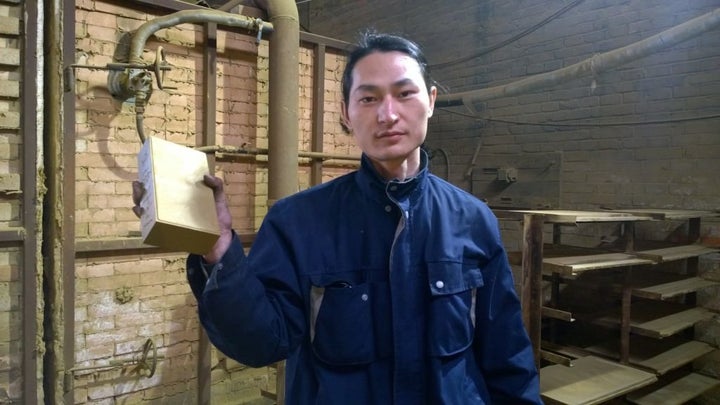 Wang holds his pollution brick. "I want to show this absurdity to more people," he said.