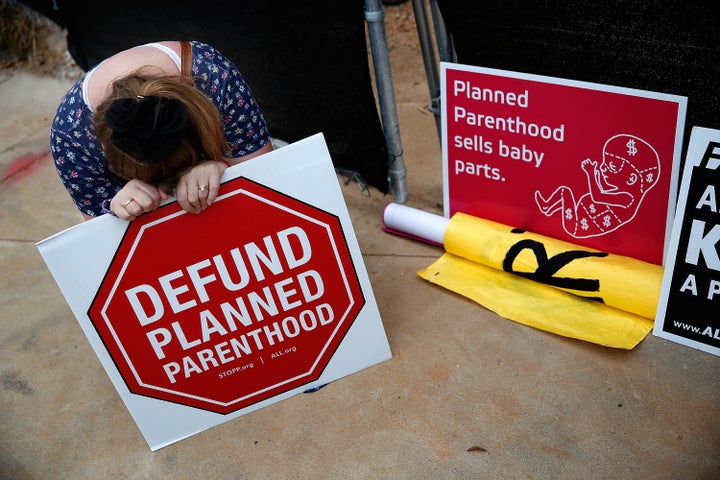 Anti-abortion activist Linda Heilman prays in front of a proposed Planned Parenthood location in Washington D.C. on Sept