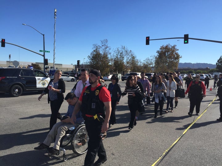 People are evacuated away from the shooting scene in San Bernardino, California, on Wednesday.