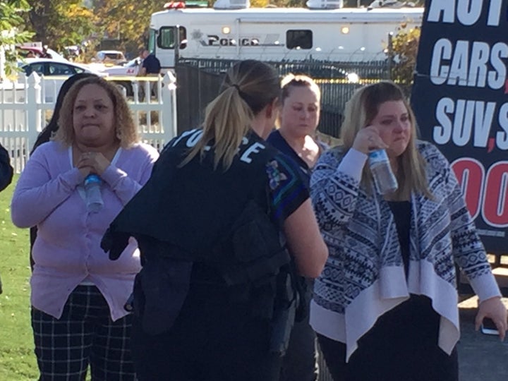 Employees of the Inland Regional Center outside the shooting scene in San Bernardino, California, on Wednesday.