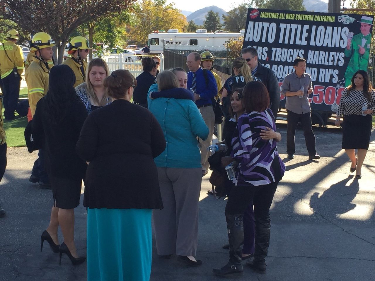 People reunite outside the shooting scene in San Bernardino, California, on Dec. 2, 2015.