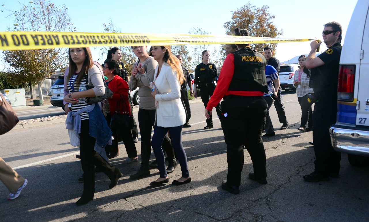 Survivors are evacuated from the scene of a shooting under police and sheriff's escort on Dec. 2, 2015, in San Bernardino, California.