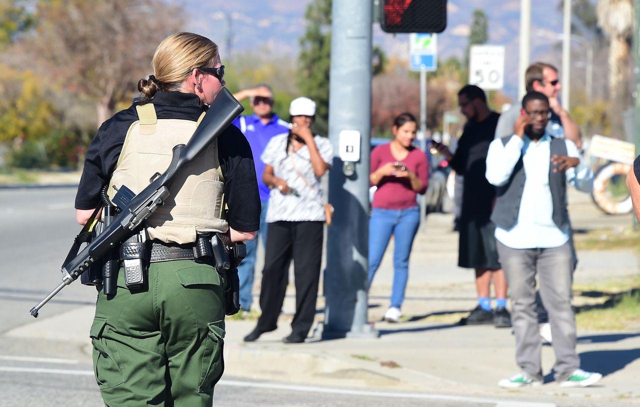 A heavily armed officer sets up a perimeter near the site of a shooting that took place on Dec. 2, 2015 in San Bernardino, California.