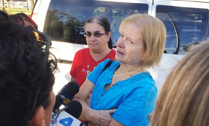 Sherry Esquerra with daughter Angel (in red) speaks to reporters near the shooting scene in San Bernardino, California, on Wednesday.