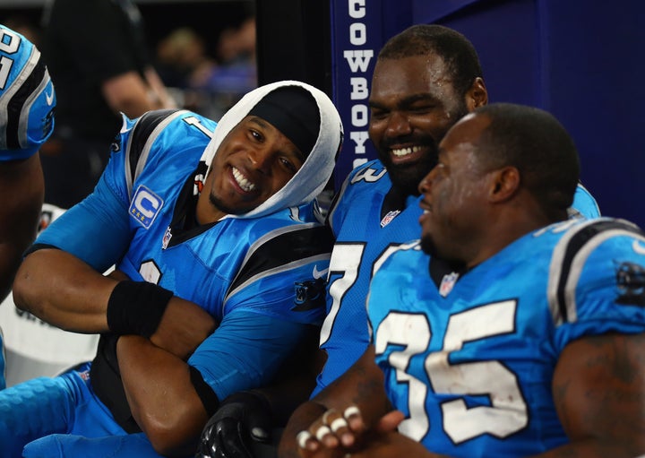 Panthers quarterback Cam Newton (left) and teammates Michael Oher and Mike Tolbert enjoy a 33-14 win over the Dallas Cowboys