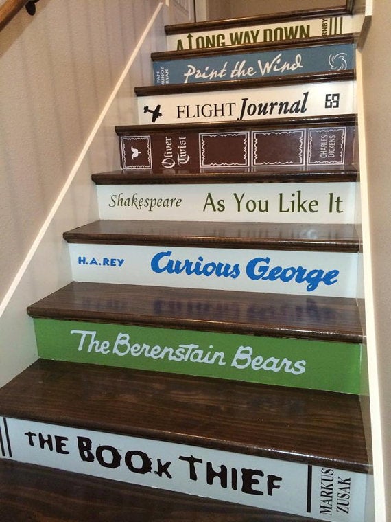 Get the <a href="https://www.etsy.com/listing/123783642/book-decals-for-stair-risers-pricedstep">book decals for stairs</a>.