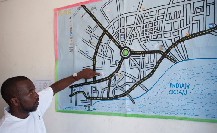 Bakari Hatib points out known heroin hotspots on a map used by The Omari Project's outreach workers. He is one of several outreach workers who provide health education and clean needles to heroin users on the streets of Malindi.