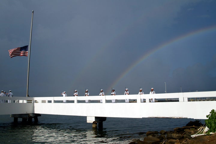 The Pearl Harbor Honor Guard presents arms at the burial at sea for Chief Yeoman Guy Pierce, who was aboard the USS Utah during the Pearl Harbor attack, Dec. 6, 2003.