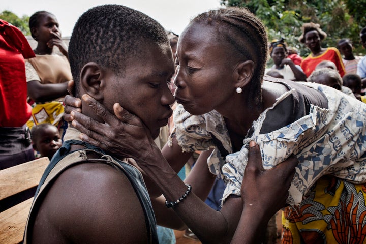 The mother of Eliam Fedongare greets him and celebrates as he arrives home with his father Jean de Dieux after the escaped the Seleka.